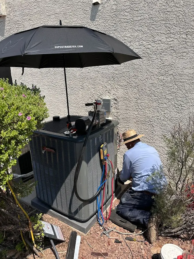 HVAC technician performing outdoor AC maintenance in Rothschild